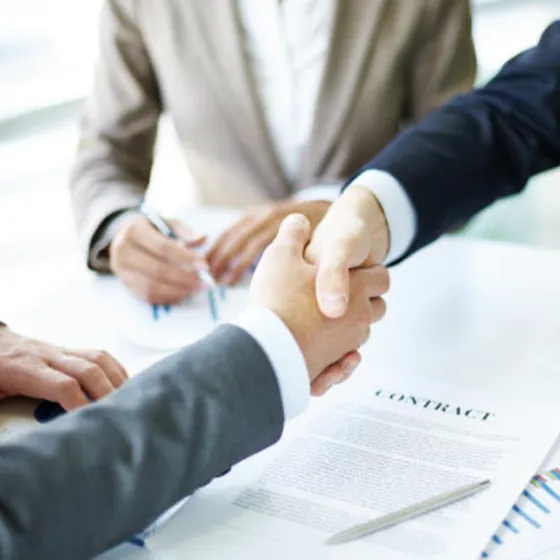 A handshake over a signed contract